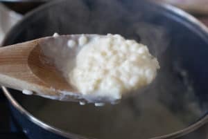 Arroz con leche in a wooden spoon