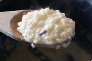 Finished arroz con leche in a wooden spoon