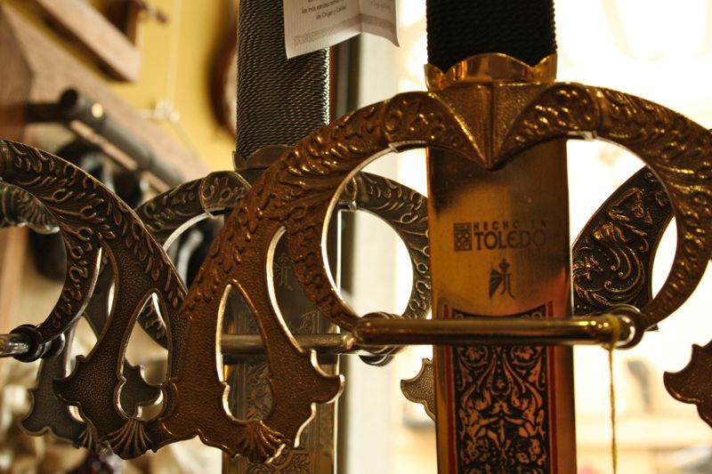 Close-up of the intricately carved metal handle of a handcrafted sword from Toledo.