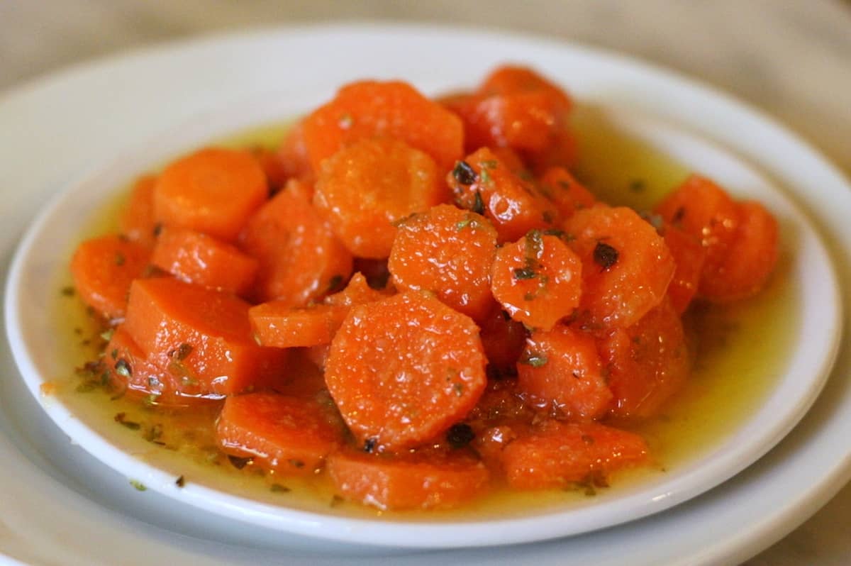 Dish of chopped carrots marinated in spices, vinegar, and olive oil.