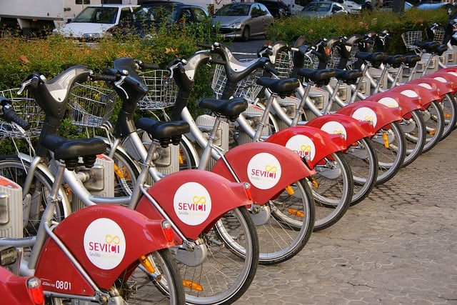 A row of Sevici public bicycles on the sidewalk in Seville