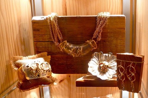 A display of metallic designer jewelry with abstract designs