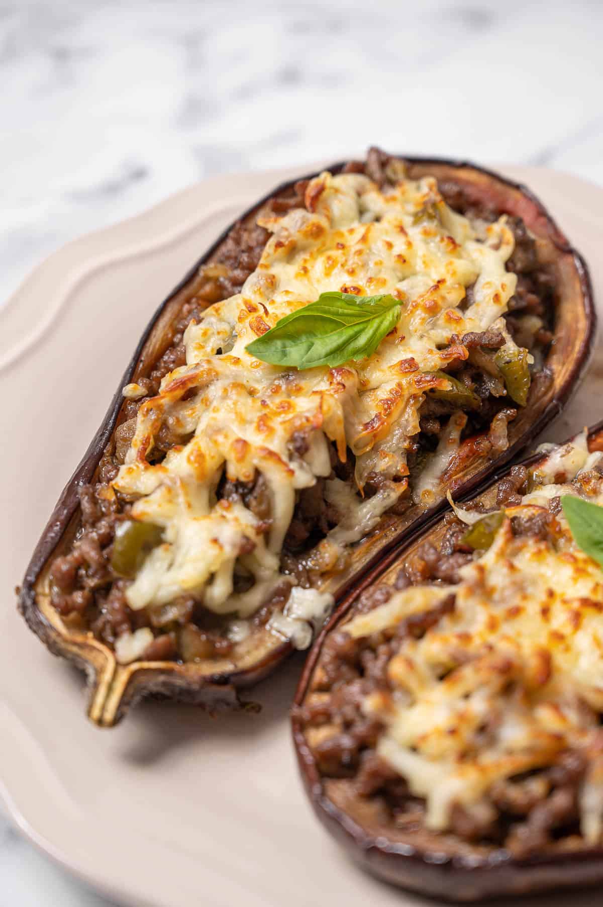 Berenjenas rellenas or Spanish stuffed eggplant on a white dish. Stuffed eggplant with meat and cheese.