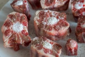 Raw bull tail (oxtail) seasoned with salt and pepper