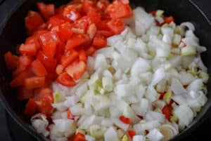 Diced onion, leek and red pepper in a cast iron skillet