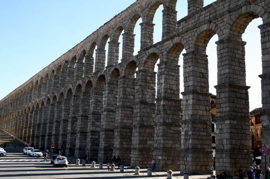 The stone arches of Segovia's aqueduct stretching far off into the distance.