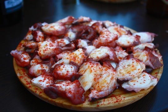 Finishing off a disc of octopus at a Galician fair is one of the food experiences in Spain that are on my bucket list