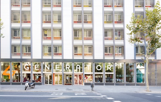 The outside of Generator Barcelona, a modern white building with large windows and balconies.
