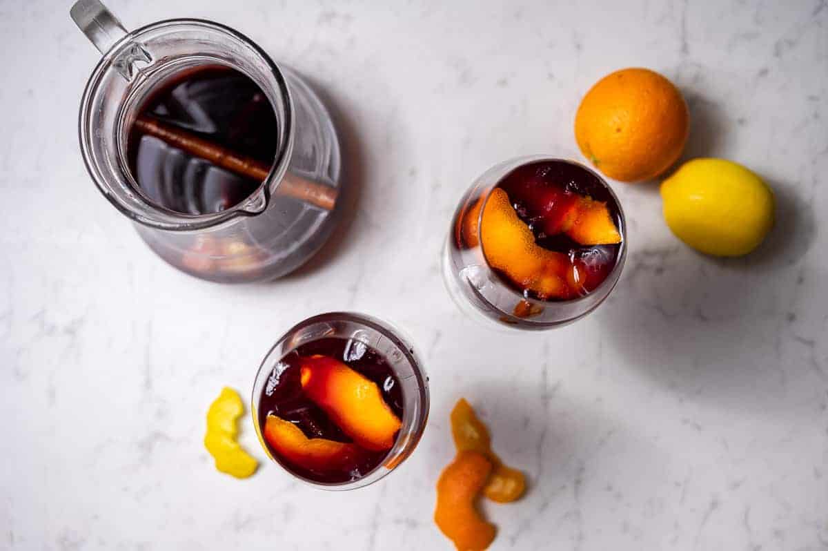 Overhead shot of two glasses and a pitcher of Spanish sangria