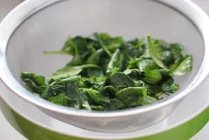 Spinach straining in a colander