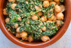 Close up of Spinach and chickpea stew in a clay dish