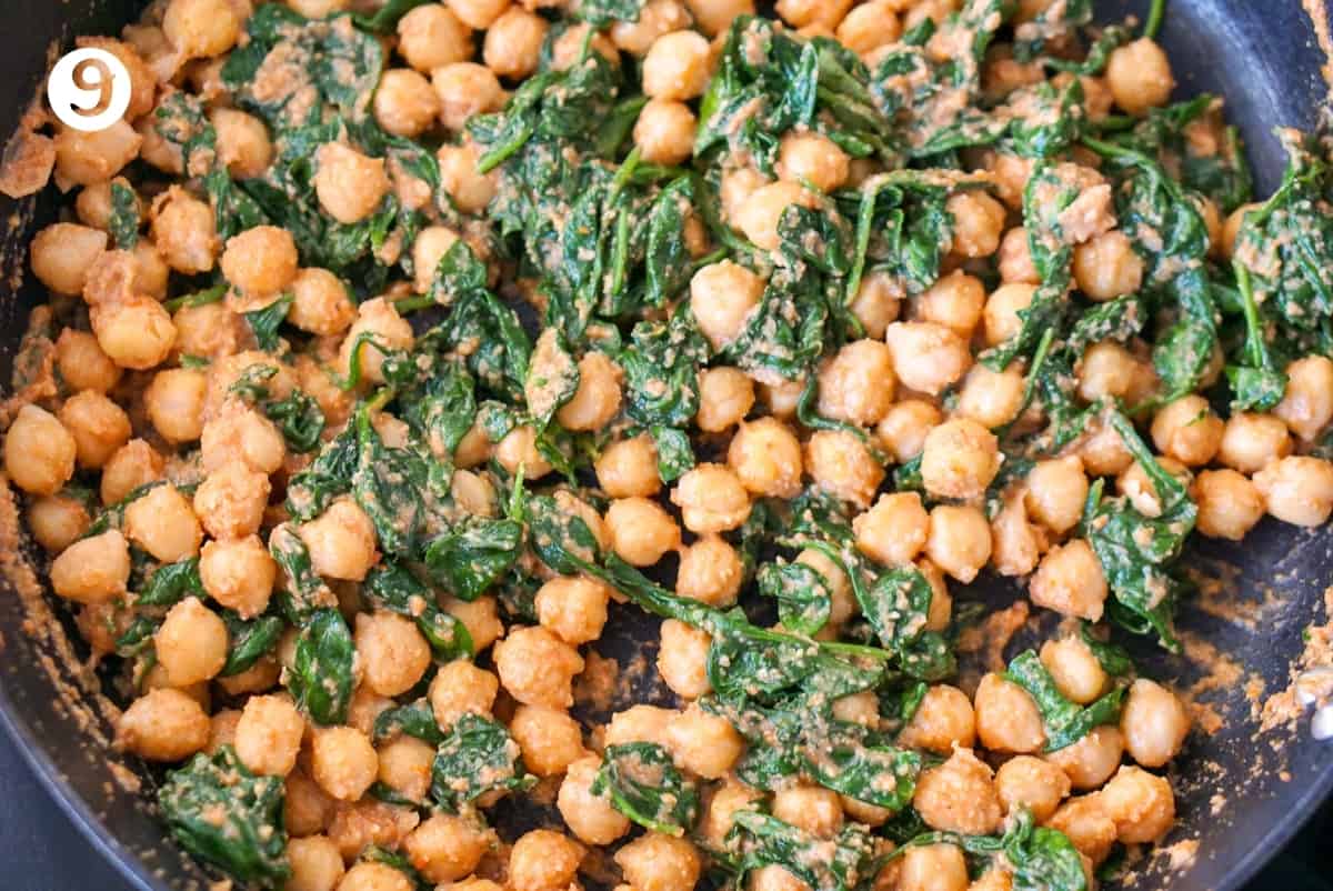 Spinach and chickpea stew step 9, adding the spinach to the pan.