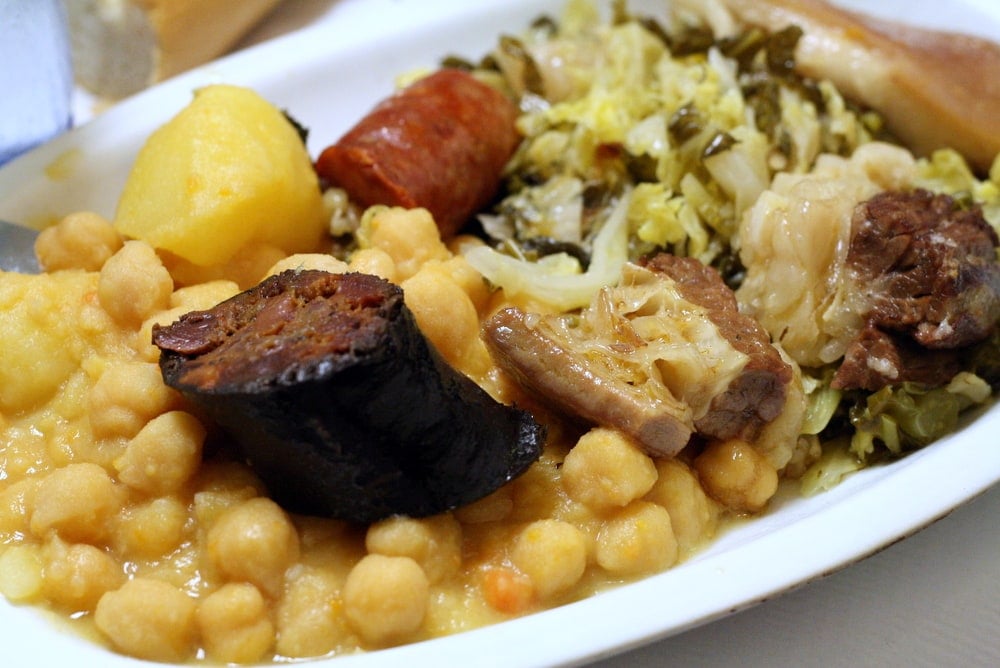 Close-up of cocido madrileño, a hearty stew of chickpeas, meats, cabbage, and potatoes