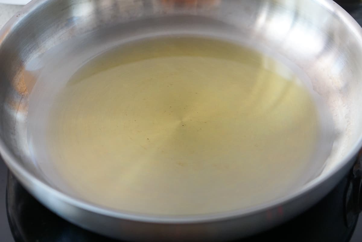 A metal pan with a thin layer of olive oil.