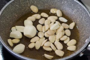 Garlic and almonds frying in olive oil