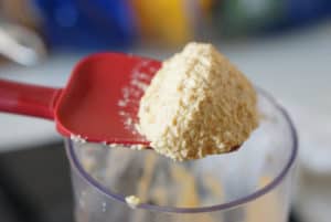 Blended almond and garlic paste on a red spatula