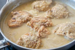 Chicken in almond and saffron sauce on the stovetop