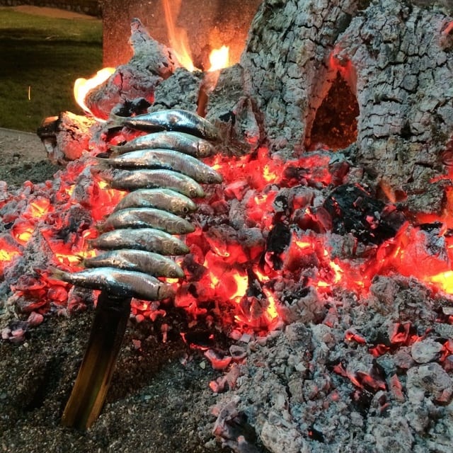 Enjoying lunch on the beach is one of our favorite ways to live like a local in Malaga. Try this sardine espeto!