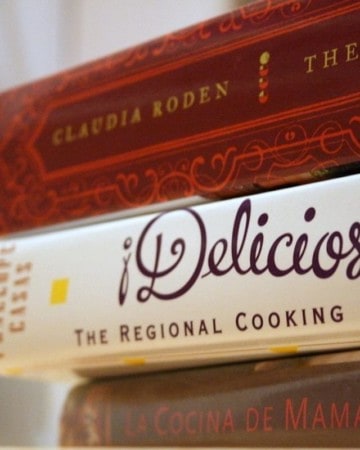 Close up of a stack of three Spanish cookbooks.