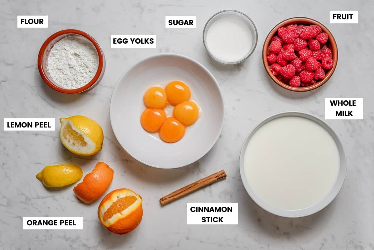 Crema Catalana ingredients on a white marble countertop