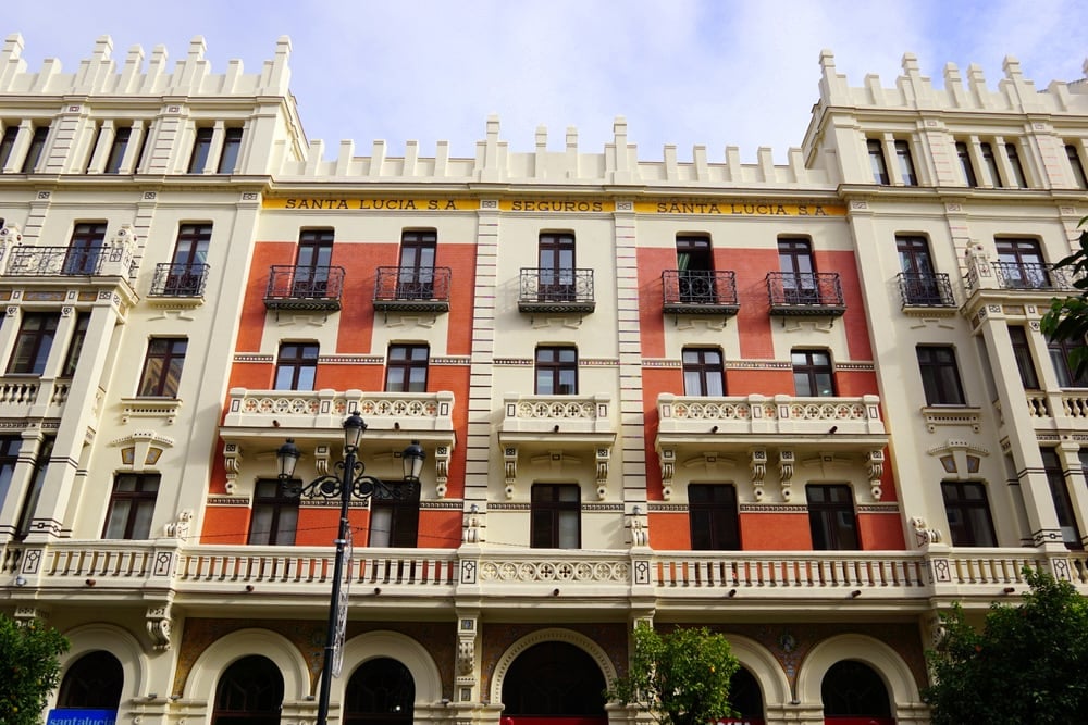 Corral del Rey Boutique Hotel in Seville, with an orange facade and ornate balconies