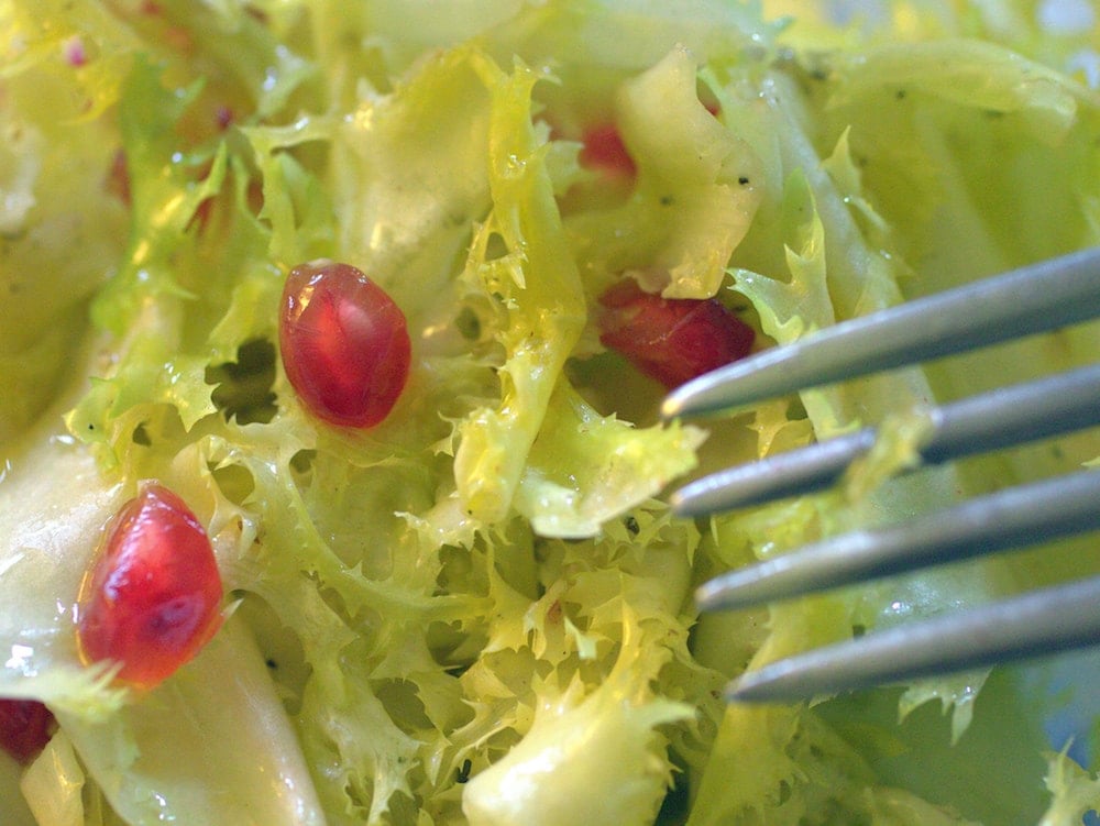 Escarole is perfect for winter salads in Spain like this one with pomegranate.