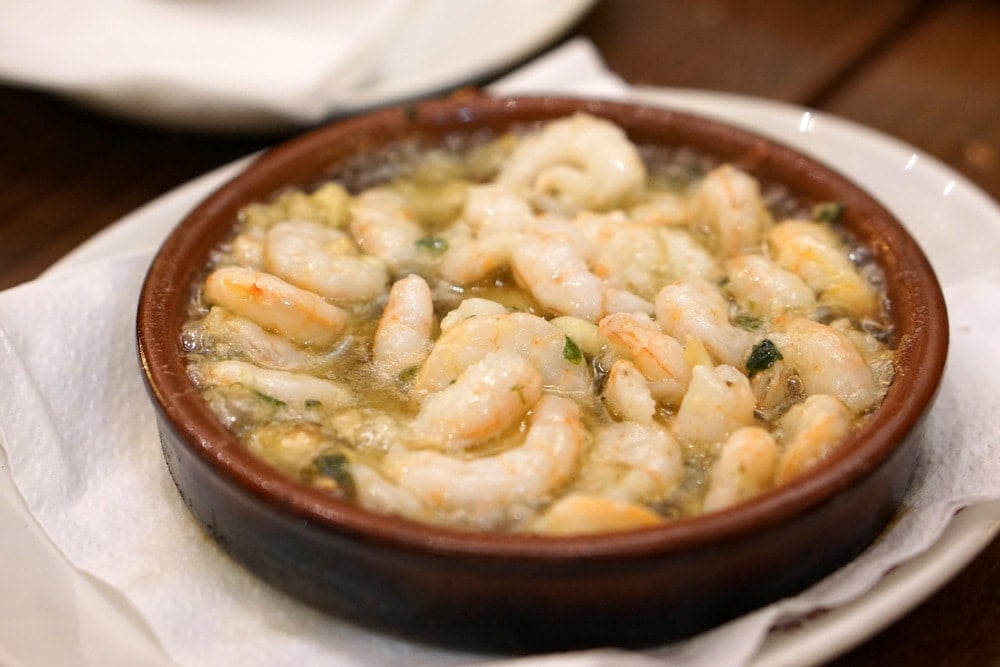 Eating garlic shrimp in Madrid on a tapas tour.
