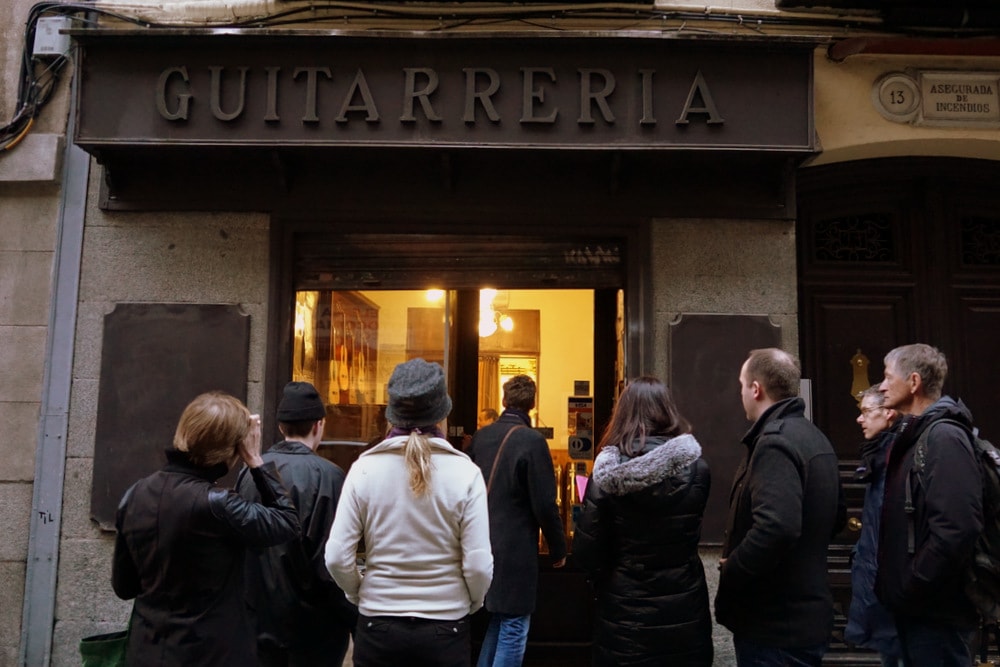 Visiting one of Madrid's handmade Spanish guitar makers on our Tapas and Flamenco Tour by Devour Spain.