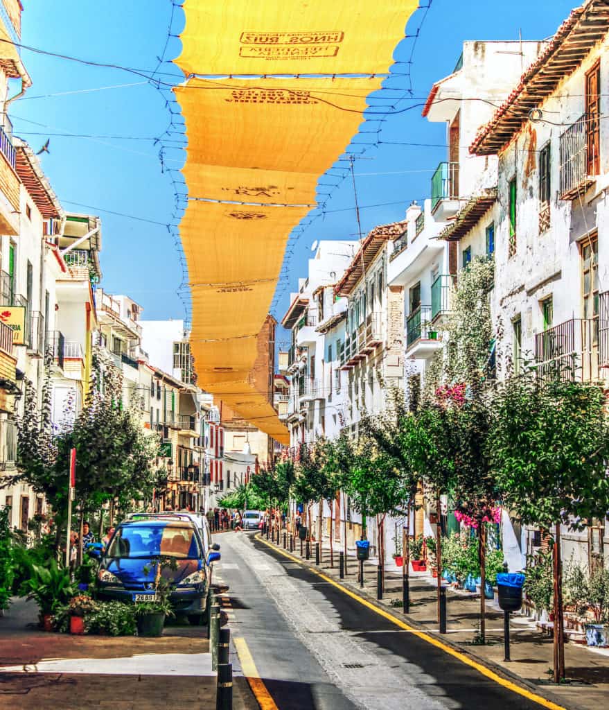Streets of Lanjarón, Spain with awnings overhead to shield from the sun