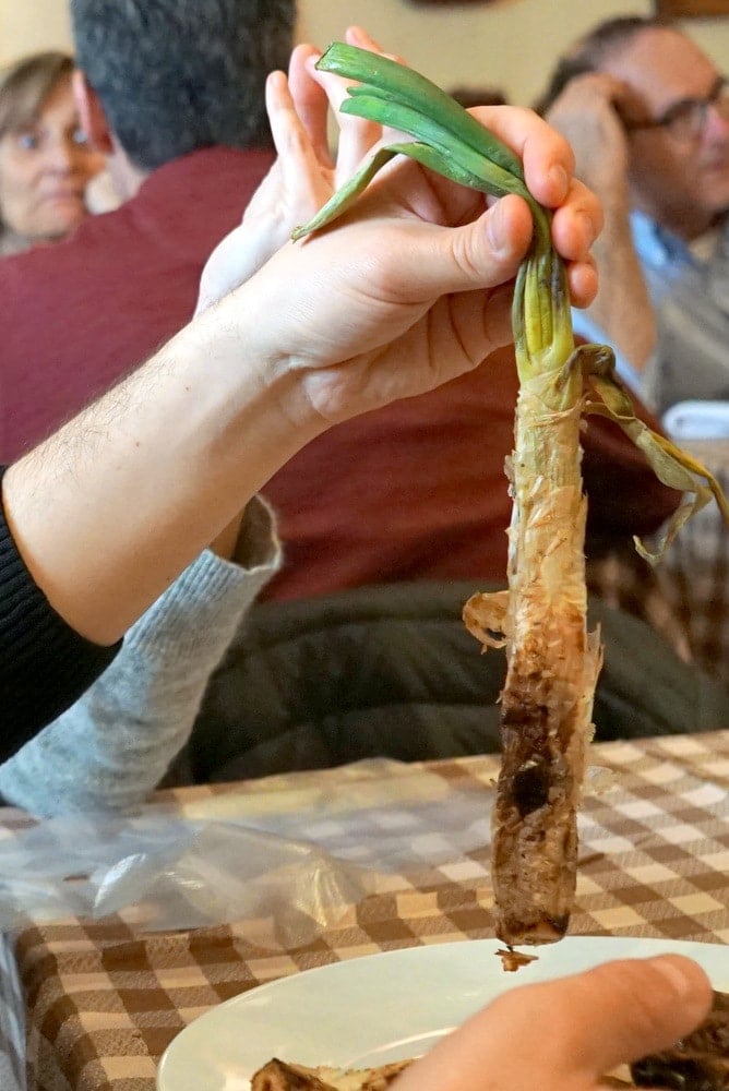 Eating calçots on a Barcelona tapas tour.