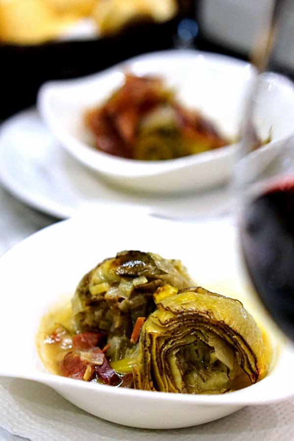 The delicious artichoke tapas and of course, red wine at Mesón Mariano, one of the best traditional tapas bars in Malaga! 