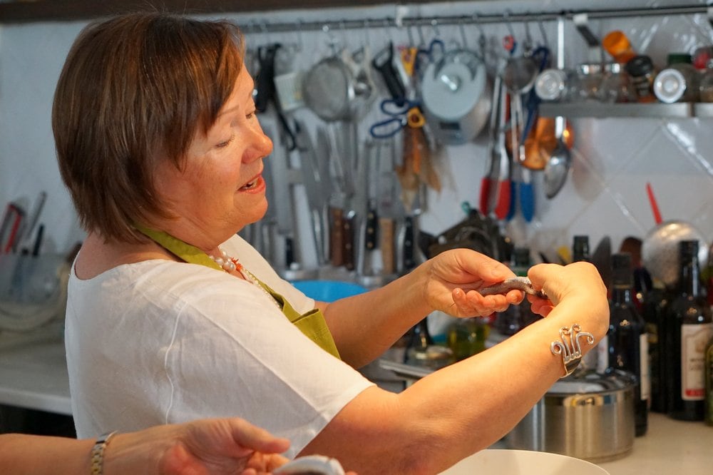 Gutting anchovies at a Spanish cooking class.