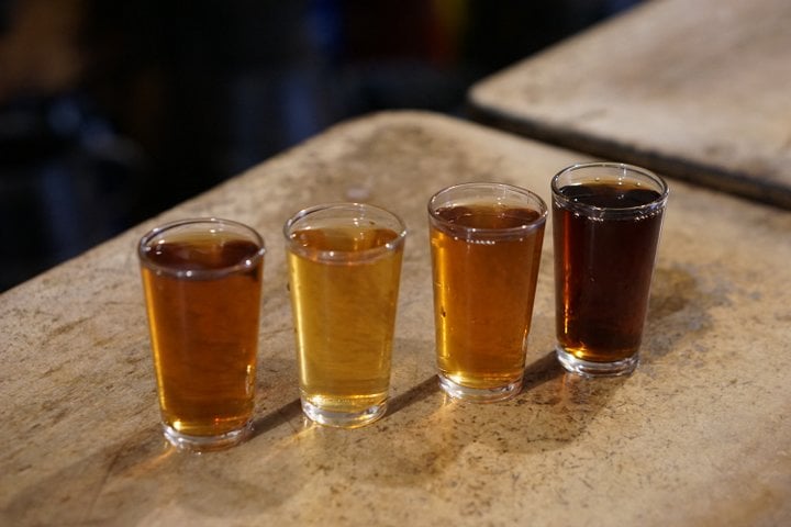 Four small glasses of sweet wine, ranging in color from gold to dark brown.