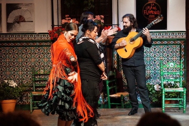 A traditional flamenco show in Seville, with a guitar player and dancers