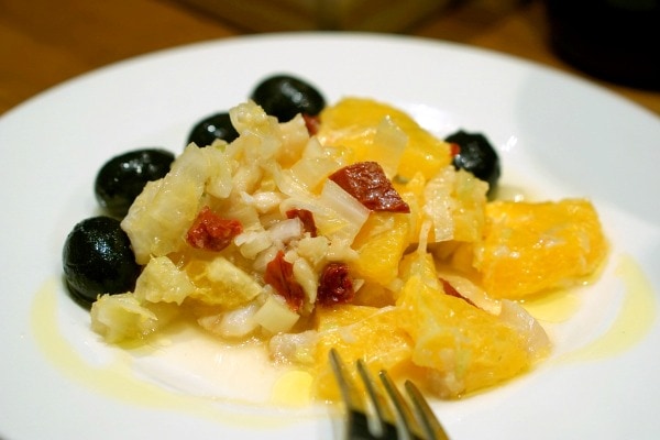 Remojón granaíno is an example of the delicious typical food in Granada. This salad includes oranges, olives, cod, and hard boiled eggs.