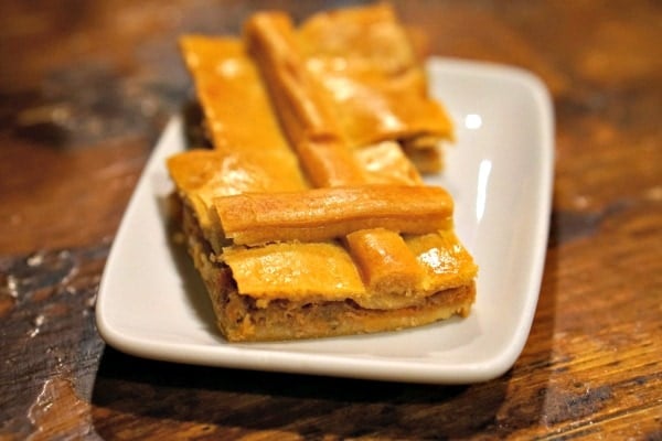 Crispy and delicious Galician empanada, a favorite dish to order at tapas bars in Santiago de Compostela.