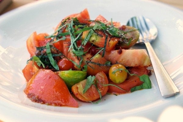 A tomato salad topped with greens—just one example of some of the fabulous vegan and vegetarian food in Santiago de Compostela!