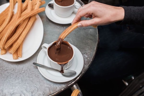 Warm up with churros con chocolate in Granada in December.