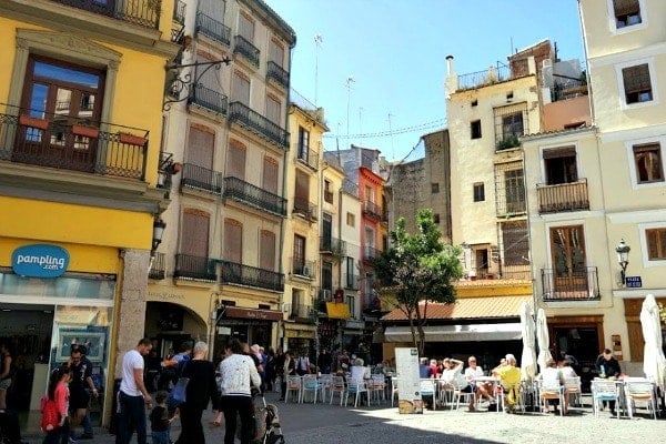 A plaza in Valencia's Old Town full of people, cafés, and old buildings 