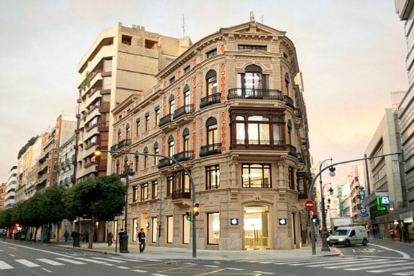 A unique building with ornate architecture on a street corner in Valencia