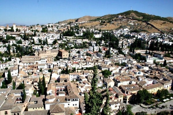 Climb to the top of the watchtower in the Alhambra to catch a stunning sunset in Granada over the Albayzín.