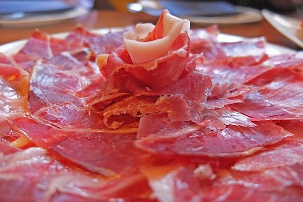 Dig into a plate of delicious Spanish ham at one our favorite historical bars in Santiago!