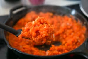 Spanish sofrito for lentils in a cast iron skillet