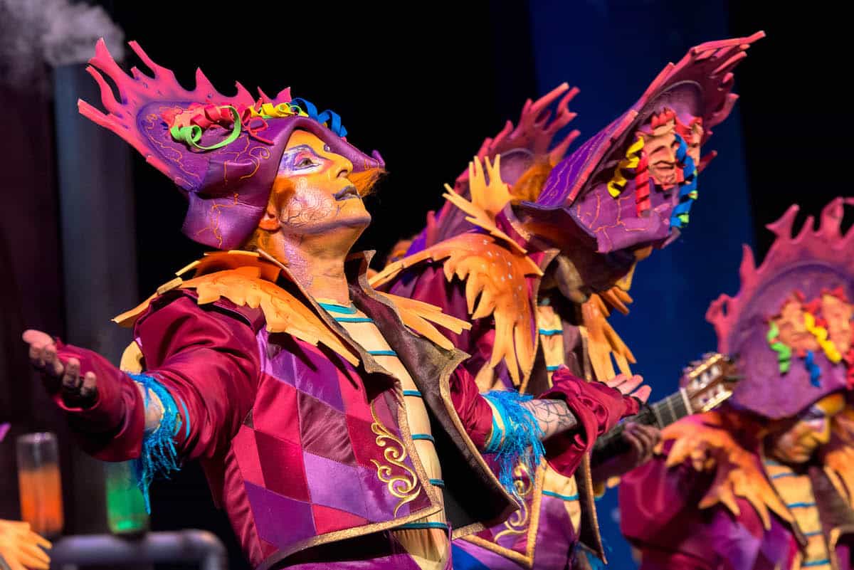 Performers in colorful costumes and makeup sing and dance at Carnival in Cadiz, Spain.