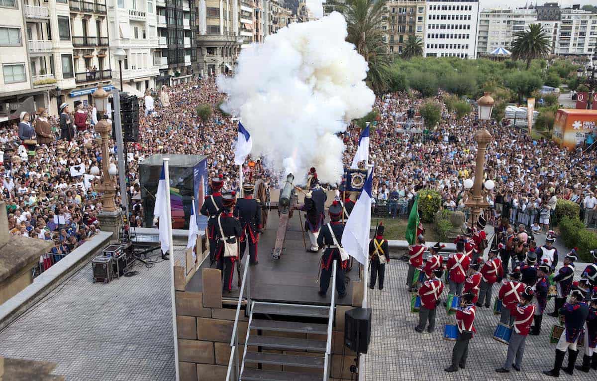 A ceremonial cannon firing at a celebration in the Basque Country, with a large crowd watching.