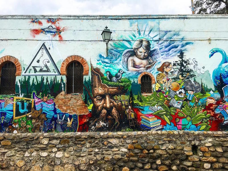 The Realejo neighborhood is home to some of the best street art in Granada, including this stunning mural outside Colegio Santo Domingo!