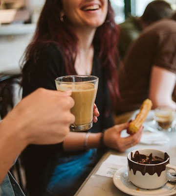 Start your morning off right at a cozy cafe when visiting Malaga in November. Don't forget the churros!
