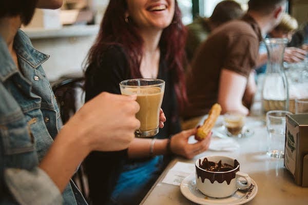 Start your morning off right at a cozy cafe when visiting Malaga in November. Don't forget the churros!