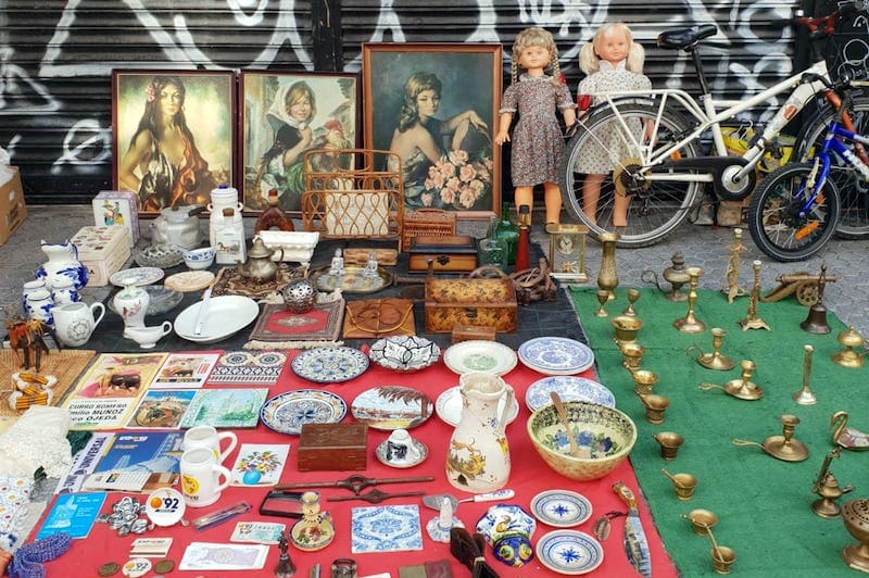 Antiques, paintings, and knick-knacks set out on the street for Calle Feria's flea market