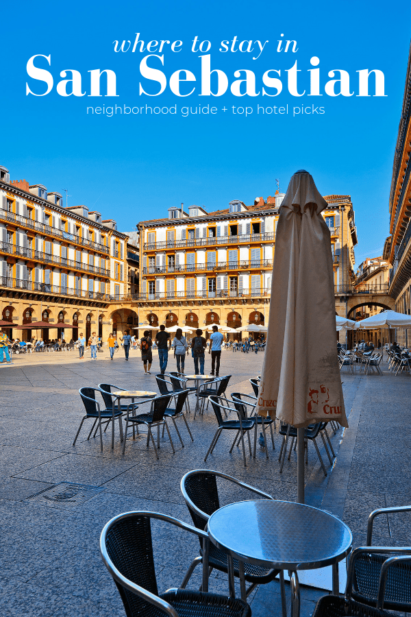 A large square in San Sebastián with cafe tables and sun-drenched buildings in the background